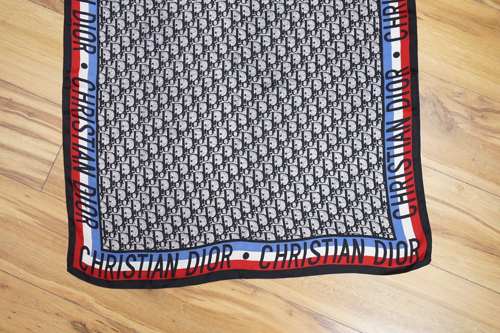 Three silk scarves comprising a Burberry check example, Christian Dior monogrammed and a Vakko abstract patterned example